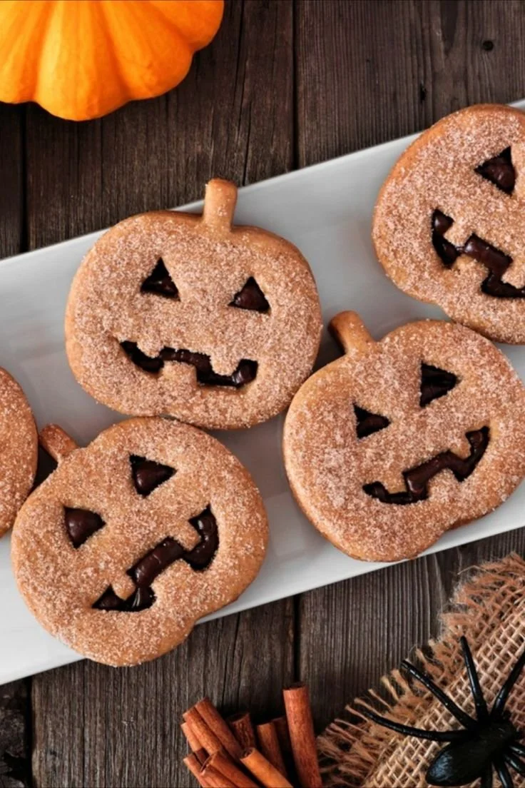 Halloween Kürbis Kekse mit Schokolade auf einem Tisch dekoriert
